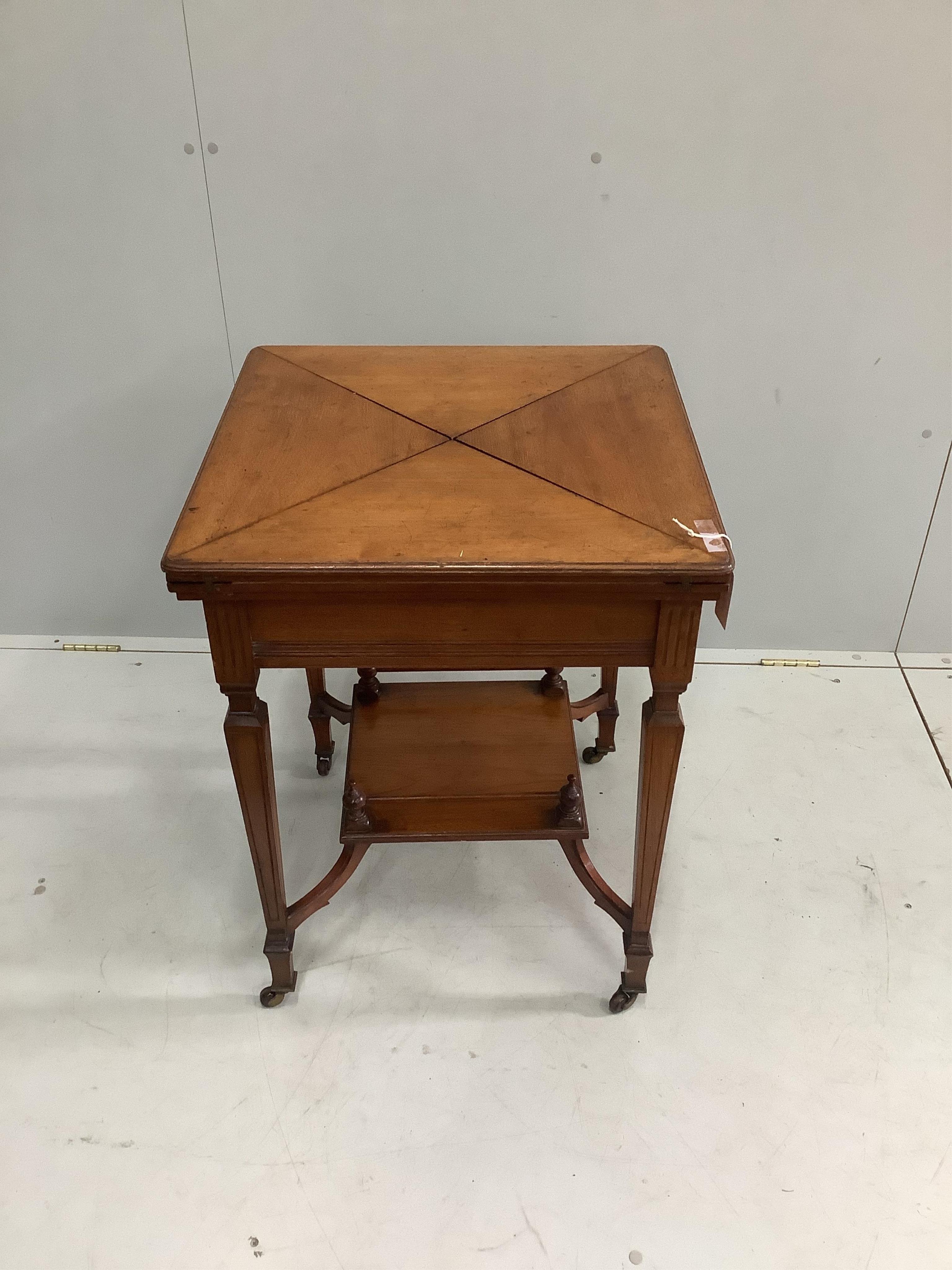 A late Victorian walnut envelope card table, width 56cm, height 74cm. Condition - fair